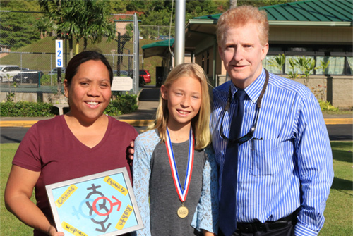 First Circuit Court Chief Judge R. Mark Browning congratulates a student for winning an annual poster contest.  Her teacher is also in the photograph.