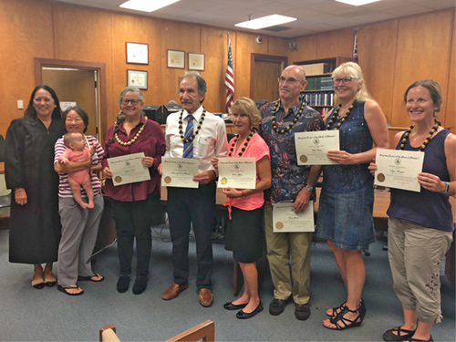 Volunteer mediators recieve certificates of recognition for their work.
