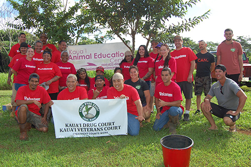 A group of volunteers pose with a "Kauai Drug Court, Kauai Veterans Treatment Court" sign at the Kauai Animal Education Center on July 26, 2019.