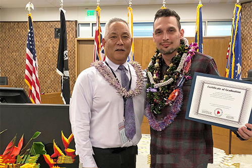 Judge Melvin Fujino with the Big Island Veterans Treatment Court’s 15th graduate, in a courtroom at the new Keahuolu Courthouse in Kona.