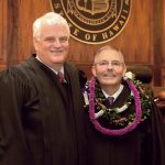 Chief Justice Mark E. Recktenwald and Associate Judge Clyde J. Wadsworth stand in front of the Hawaii Supreme Court courtroom bench after Wadsworth’s swearing in ceremony, 11/12/19.