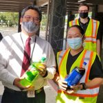 Hilo Drug Court Judge Henry Nakamoto (left), Friends of Big Island Drug Court Vice President Michelle Manalo, and Drug Court Probation Officer Dustin Cueva (back) at the 03/02/21 Hilo Civic Center food distribution event.